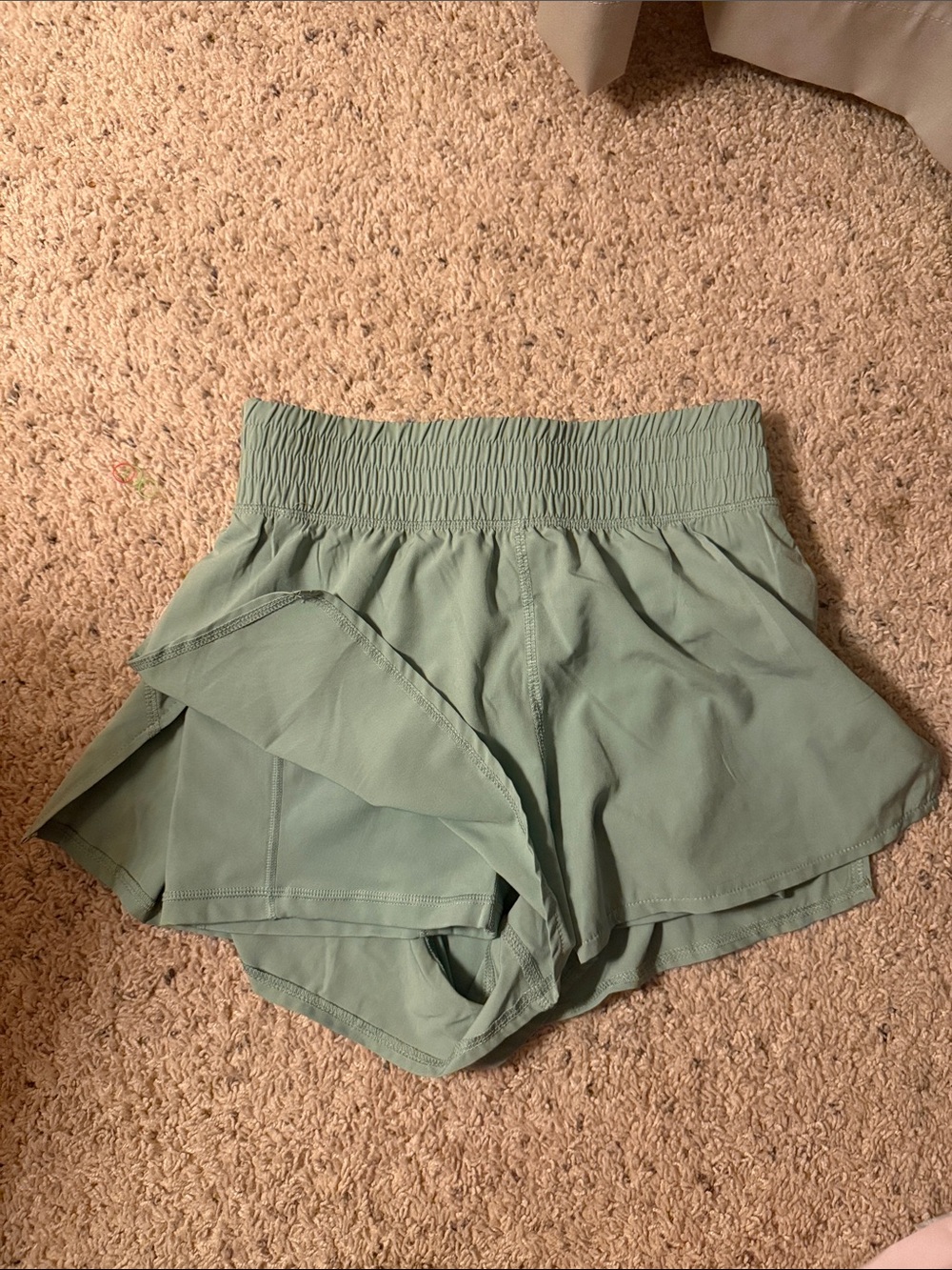 High waist sage colored shorts with liner and pocket